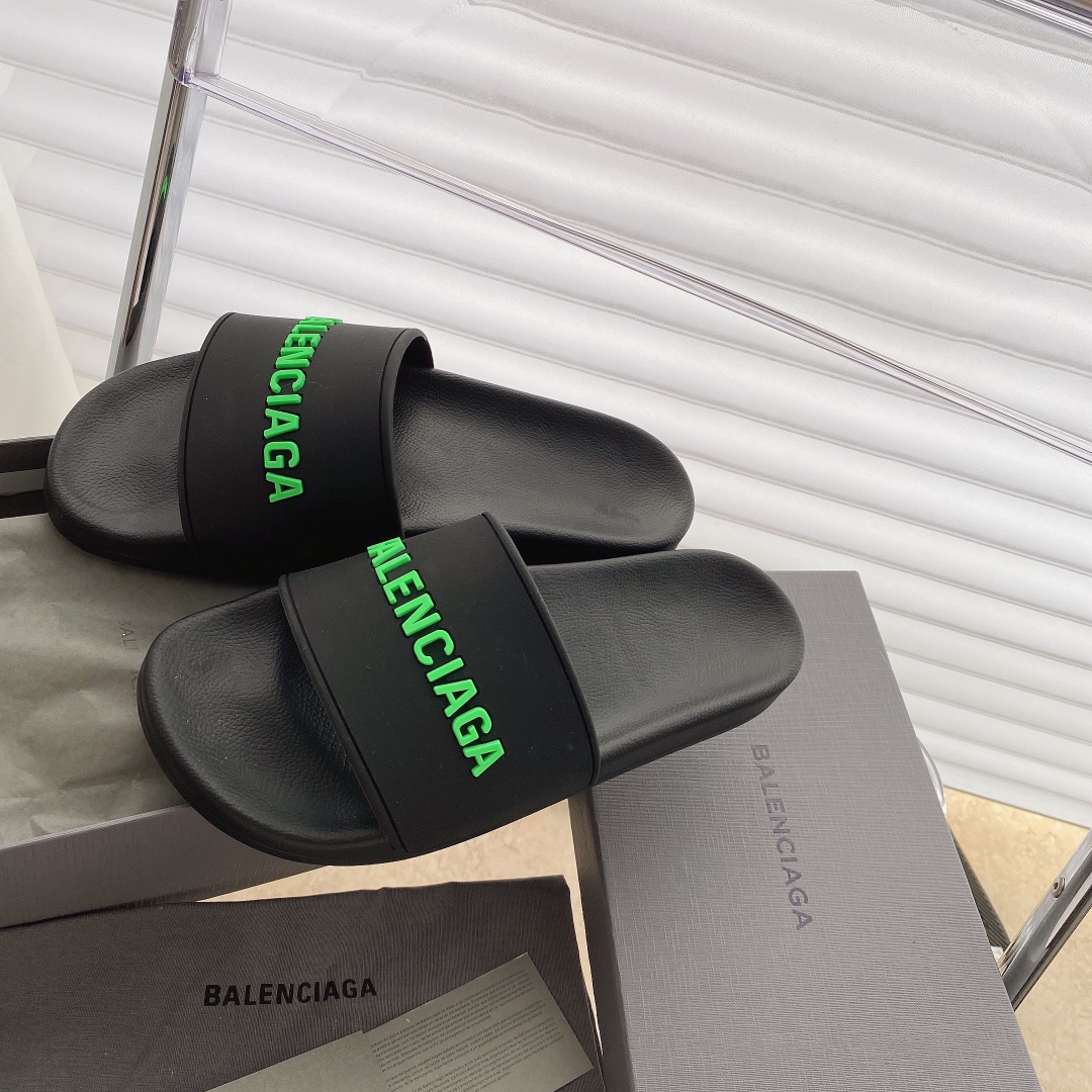 Balenciaga Pool Slides in black with green logo